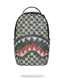 A Spraycraft Shark backpack featuring a black and white checkerboard pattern with cartoon face details, a large shark mouth graphic in red and white on the front pocket, and a top carry handle. By Fresh N Fitted