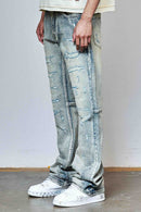 First Row allover rhinestone flare fit denim jeans in medium stone tint, showcasing detailed embellishments and classic denim style.