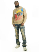 Man wearing a beige hoodie with graphic design and distressed jeans on a white background. By Fresh N Fitted.