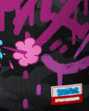 Sprayground Smurfs Shark Tag backpack featuring a colorful shark design, durable fabric, adjustable straps, and logo branding.