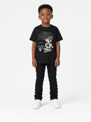 A young boy modeling a black graphic t-shirt, black distressed jeans, and white sneakers against a plain white studio background.