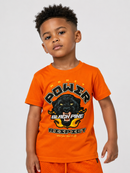 A young boy wearing a bright orange t-shirt with a black panther graphic and the words 'POWER BLACK PIKE RESPECT' on the front, paired with matching orange shorts, against a light gray background.