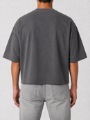 Grey Papercut 'God is Good' oversized cropped T-shirt displayed on a hanger, showcasing the front design and relaxed fit.