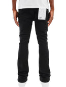 Black denim jeans with a white patterned patch pocket on the back, shown on a model from the back against a white background.