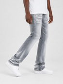 A person wearing light gray washed denim jeans with a white t-shirt and white sneakers, shown from the waist down against a plain light gray studio background.