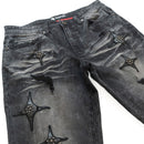 Black distressed jeans with star-shaped embellishments on a white background. By Fresh N Fitted