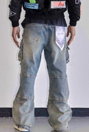 First Row Y2K utility cargo denim jeans in medium stone tint, featuring multiple pockets and distressed style.