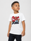 A young boy wearing a white short-sleeve t-shirt with a colorful 'Get It Done' graphic on the front, paired with dark jeans, photographed against a light gray studio background.