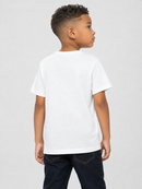 A young boy with short curly hair is shown from the back wearing a plain white short-sleeve t-shirt and dark blue jeans, standing against a light gray studio background.