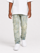 A child wearing light-wash distressed denim jeans with ripped details, a white t-shirt, and white sneakers, shown from the waist down against a plain white studio background.