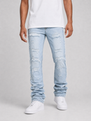 A person wearing light-wash distressed jeans with ripped details, paired with a white t-shirt and white sneakers, shown from the waist down on a light gray studio background.