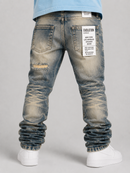 Rear view of a person wearing distressed light tint denim jeans with rolled cuffs, a white shirt hem, and white sneakers against a light gray studio background. A large white back patch reads EVOLUTION. By Fresh N Fitted.