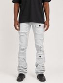 A person wearing light-wash distressed denim jeans with frayed details and cargo-style pockets, paired with a black t-shirt and black shoes, photographed against a plain light background.