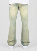 A pair of light-wash, faded blue jeans with a wide leg and front patch pockets, shown from the back on a model wearing a white t-shirt and white sneakers against a light gray background.