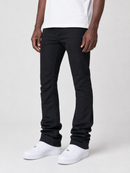 A person wearing slim black pants with a white t-shirt and white sneakers, shown from the waist down against a light gray studio background.