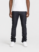 A model wearing dark wash slim-fit jeans, a white t-shirt, and white sneakers, standing against a light gray studio background.